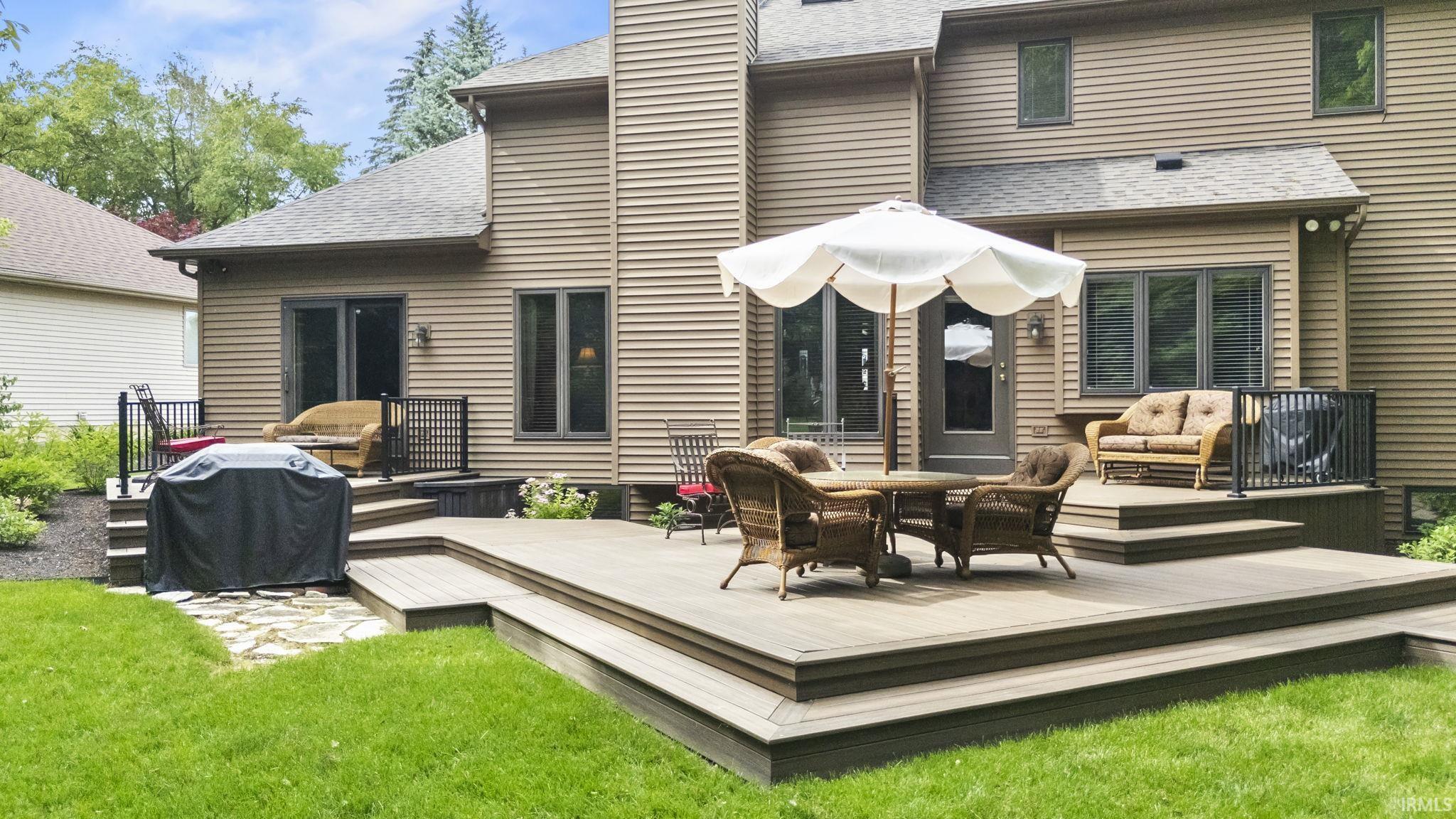 Multi-level deck with composite decking, black metal railings, and a tiered design