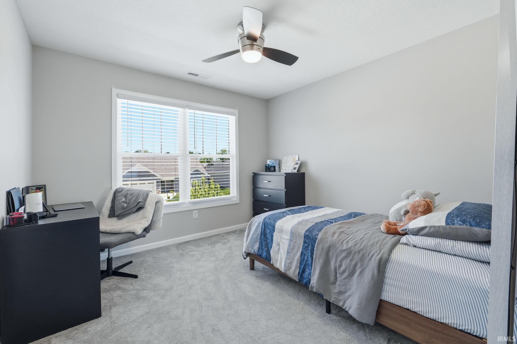 Light gray wall paint, textured ceiling, and gray carpet flooring