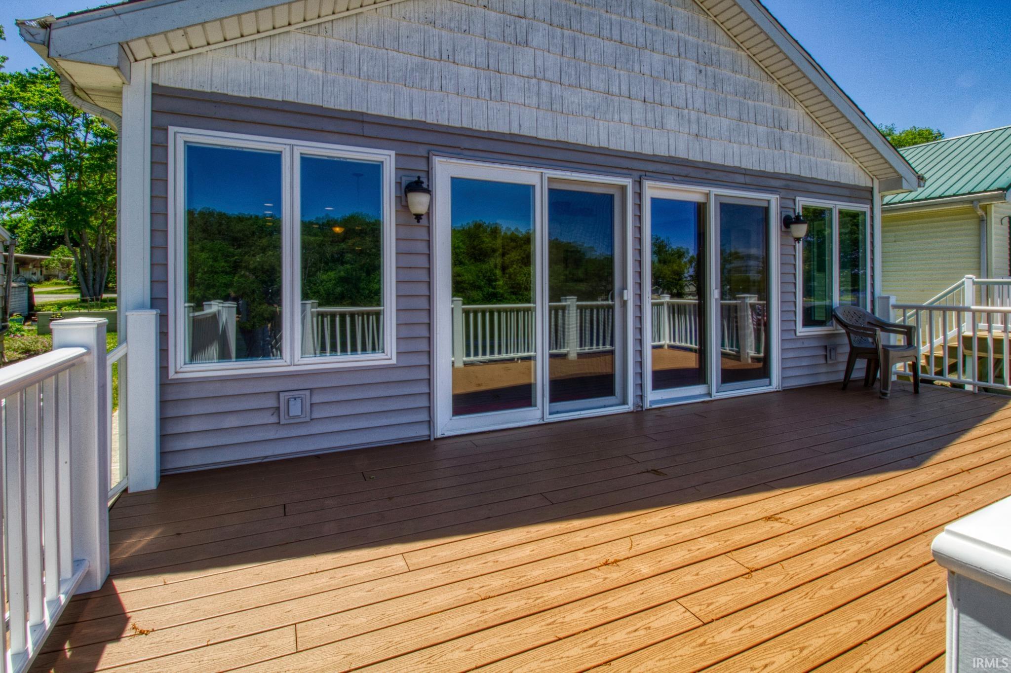 Spacious outdoor deck featuring wood-finish flooring