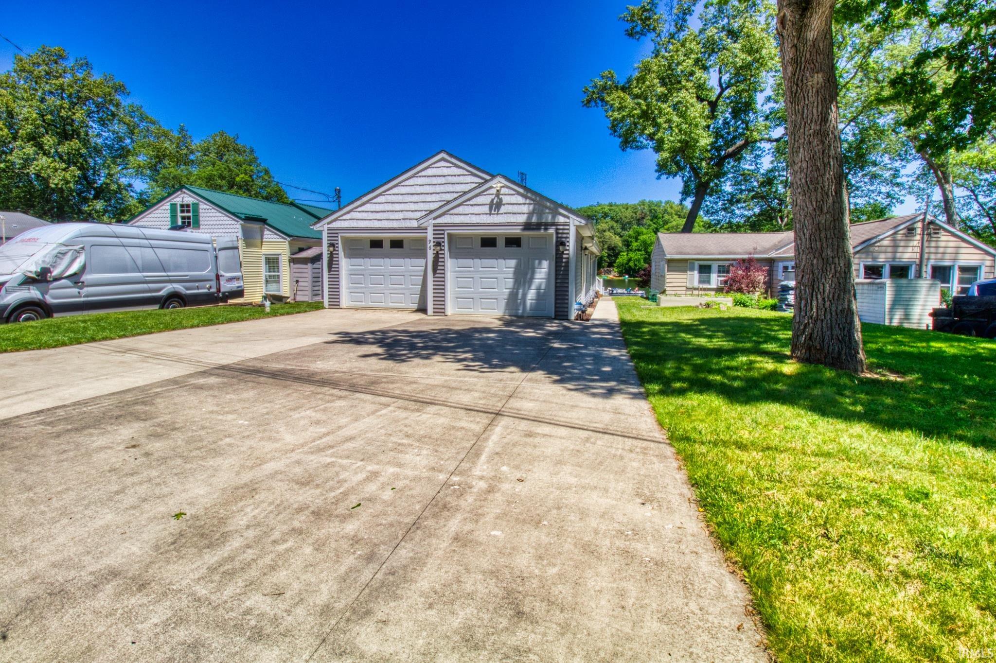 Garage with shaker-style doors and exterior siding
