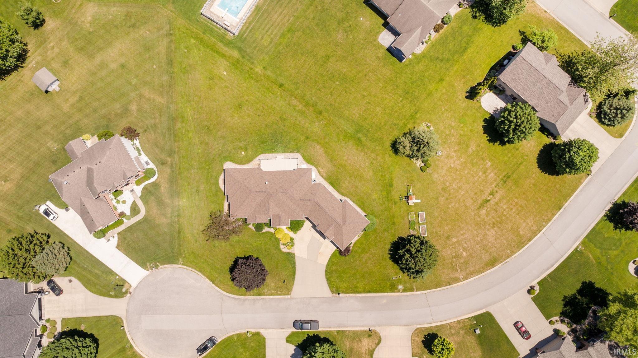 Spacious residential property with a multi-gabled roofline and an expansive front lawn