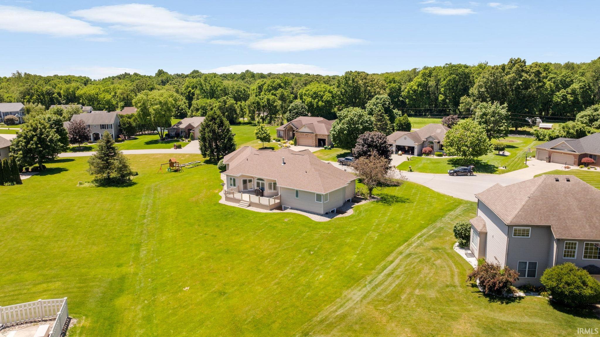 Spacious lot with extensive green lawn and mature perimeter trees