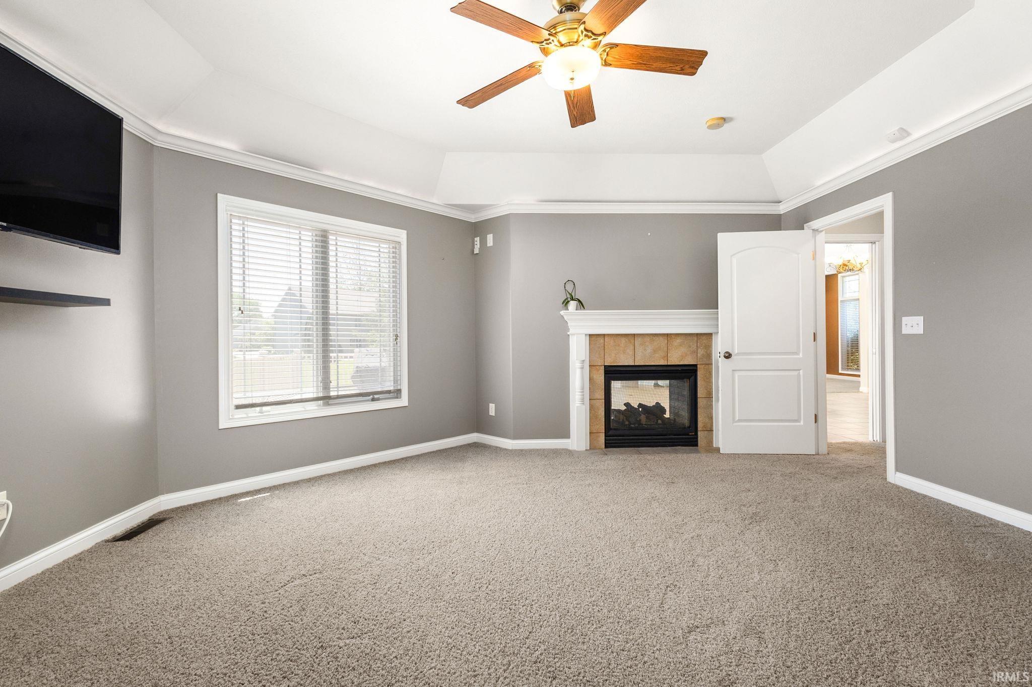 Featuring a fireplace with a light-colored wood mantel