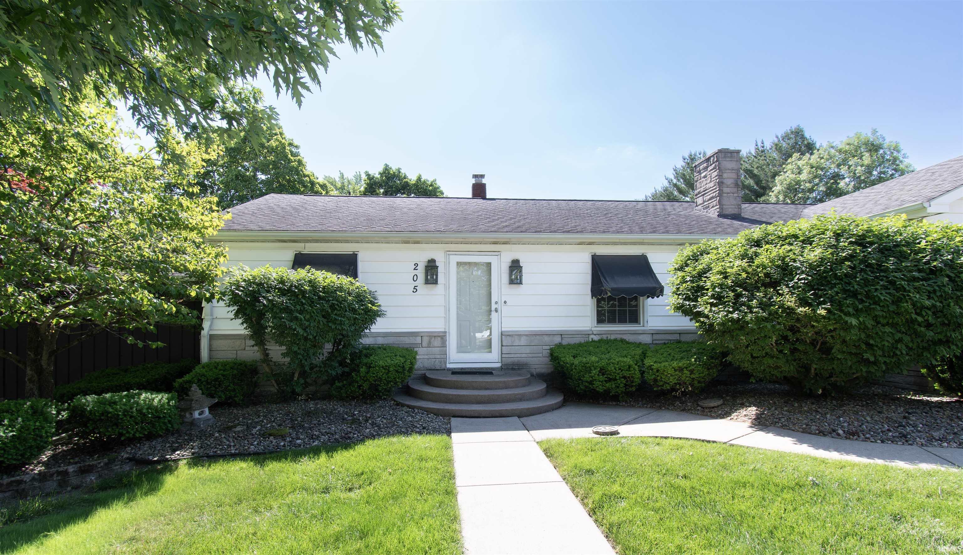 White siding exterior with a stone veneer foundation