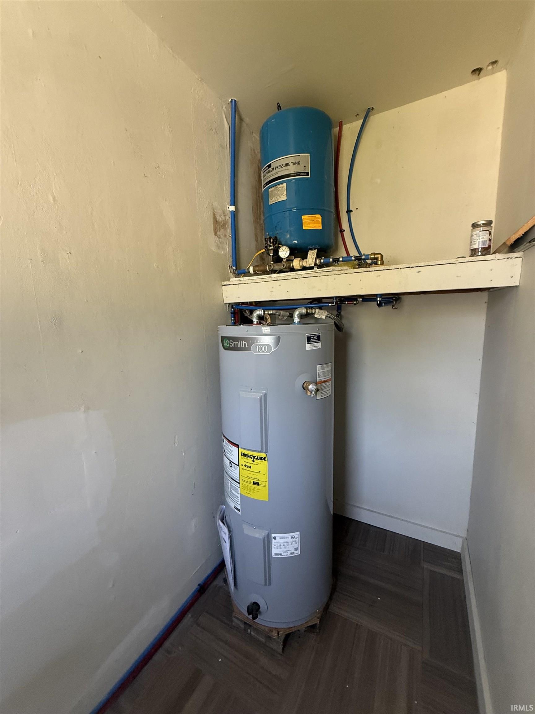 Water heater and pressure tank system installation on wood-finish flooring