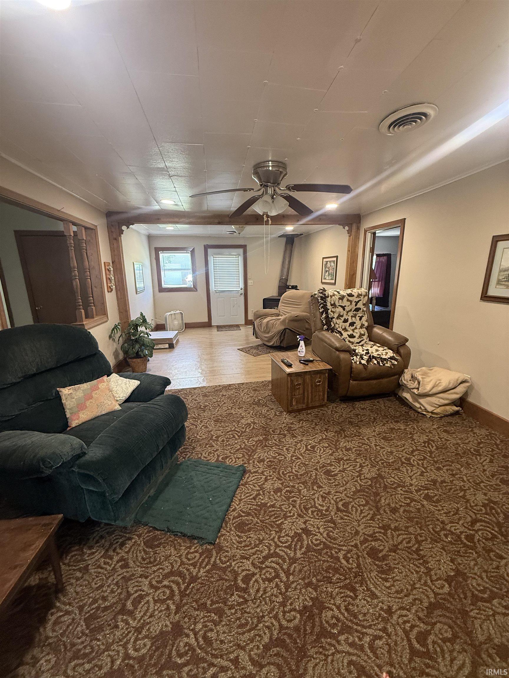 Spacious interior featuring patterned carpet and wood-finish flooring