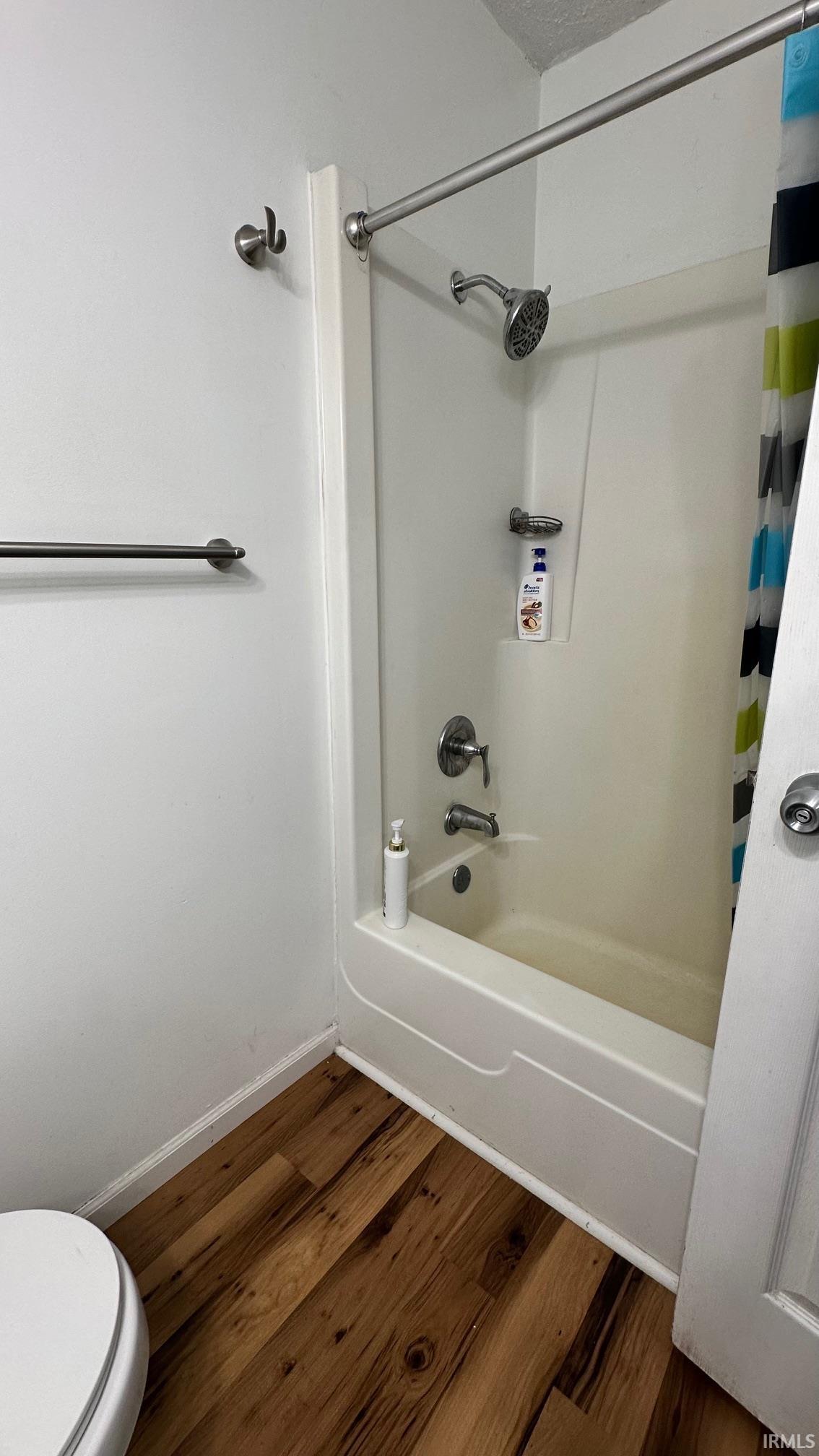 Bathroom featuring a white tub/shower combination with a chrome shower head and faucet