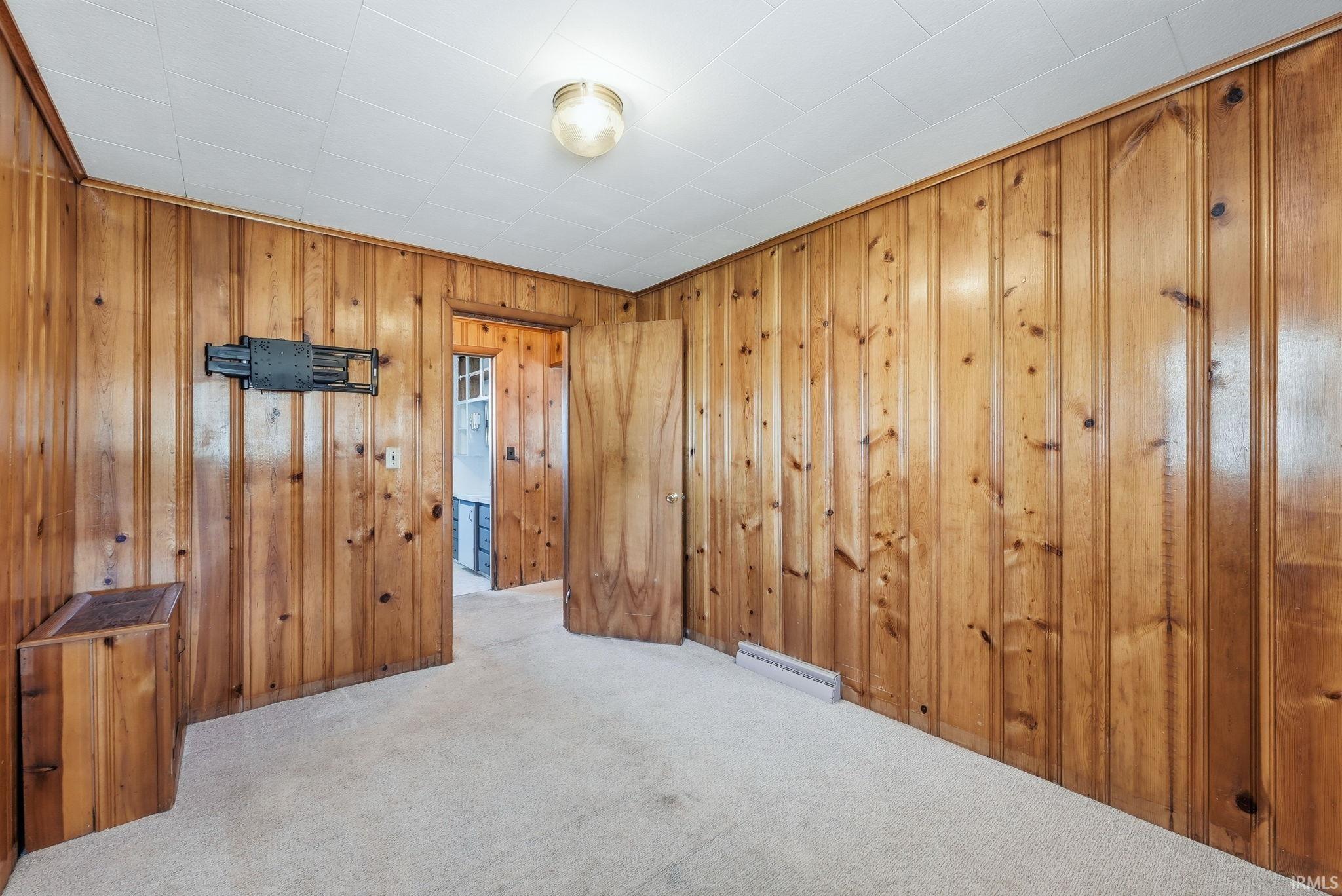 Room featuring wood paneling on walls