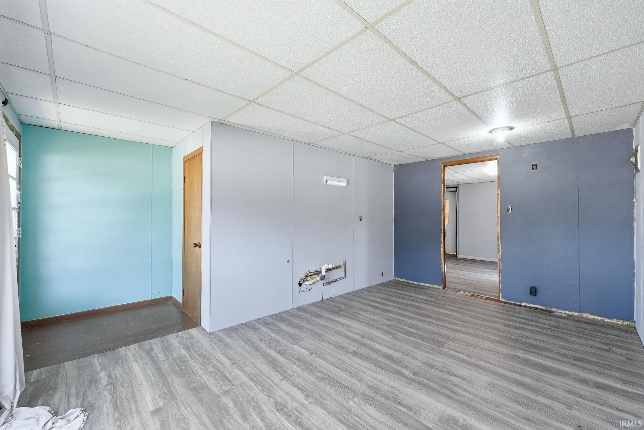 Interior space featuring wood-finish flooring and a drop ceiling