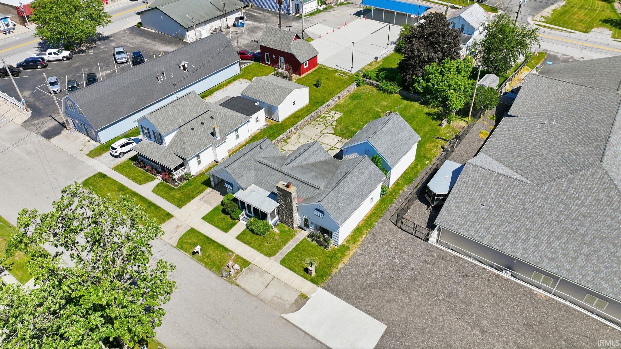 Aerial perspective showcasing a residential property with an expansive yard