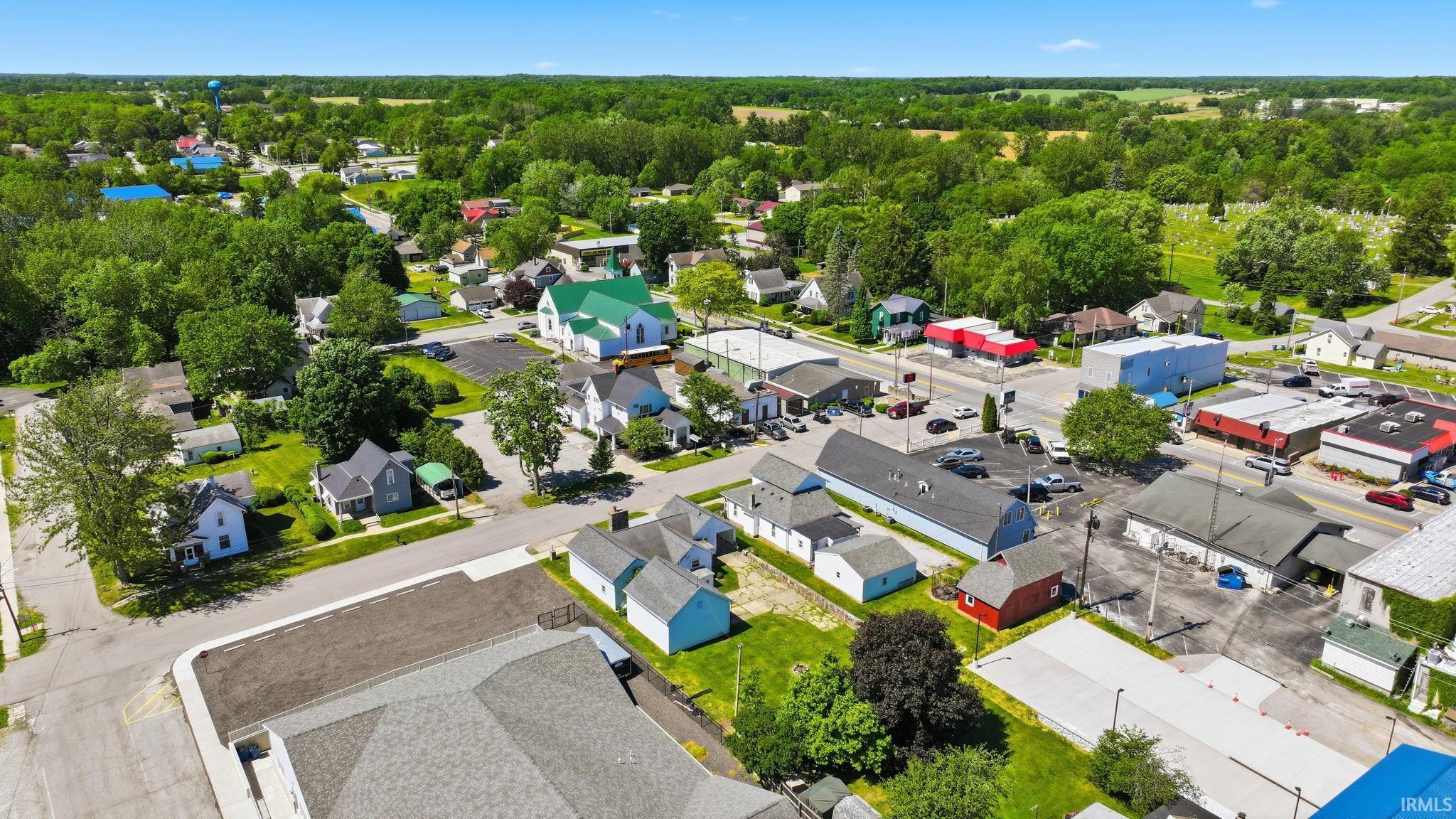 Aerial perspective showcasing a mixed-use neighborhood with residential properties and commercial buildings