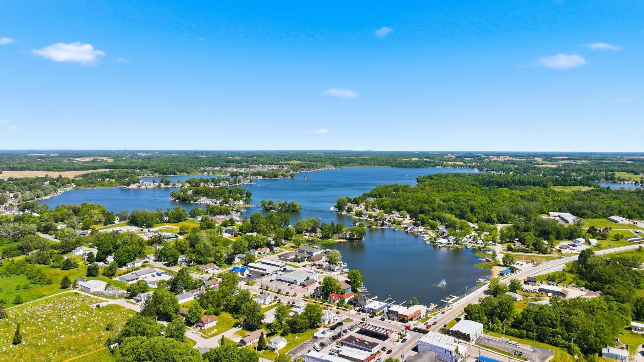Aerial perspective showcasing a sprawling lake system surrounded by established residential areas and abundant mature trees