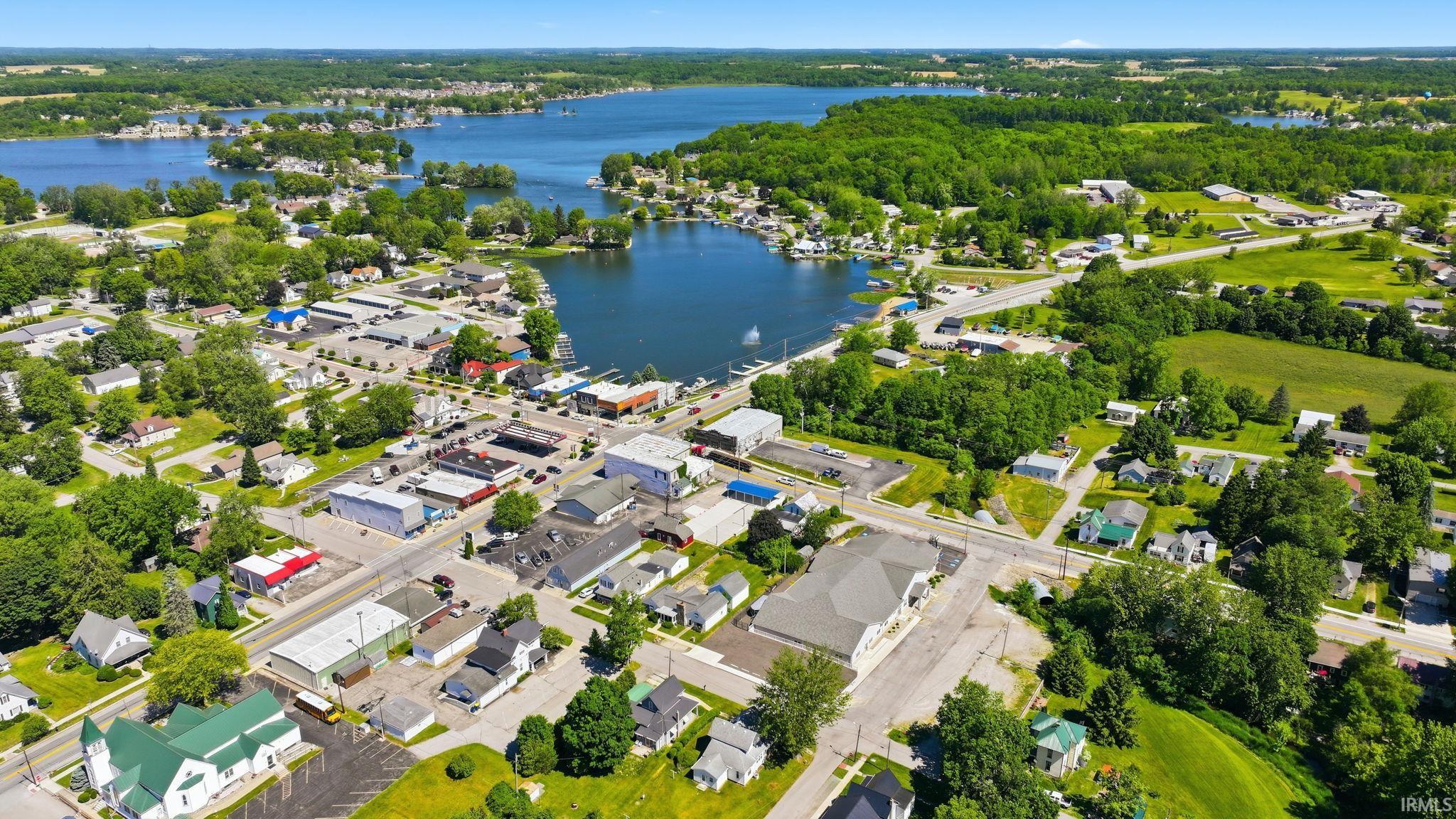 Aerial perspective showcasing a waterfront community with a mix of residential and commercial properties