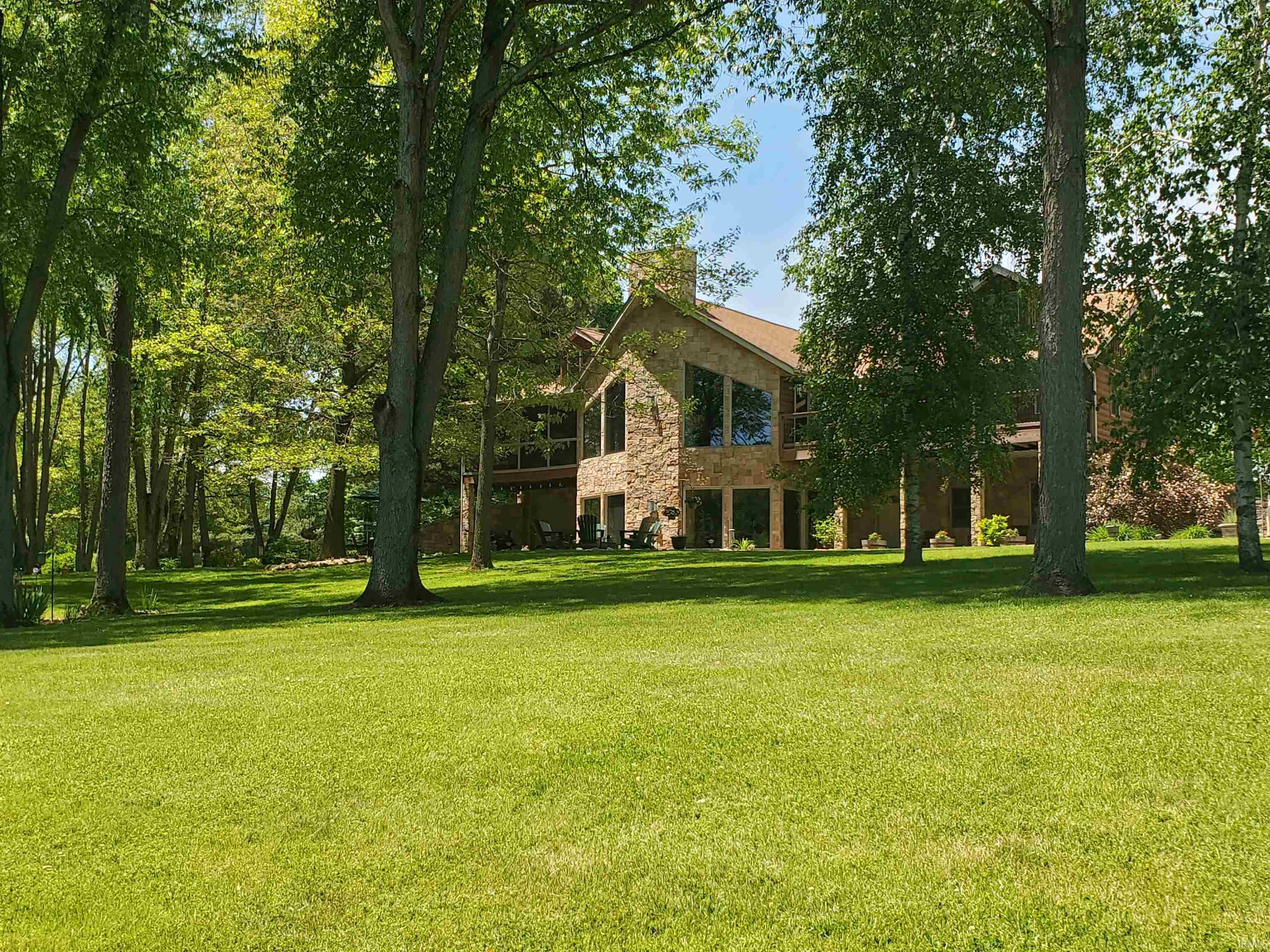 Spacious lawn surrounded by mature trees