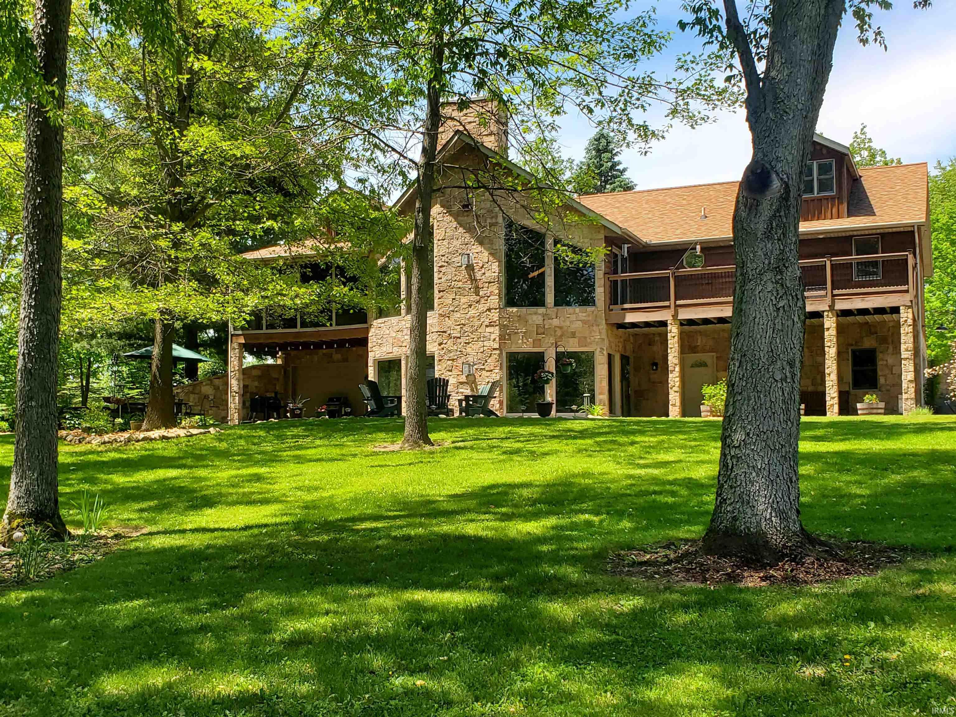 Stone and wood-sided residence featuring a multi-level design