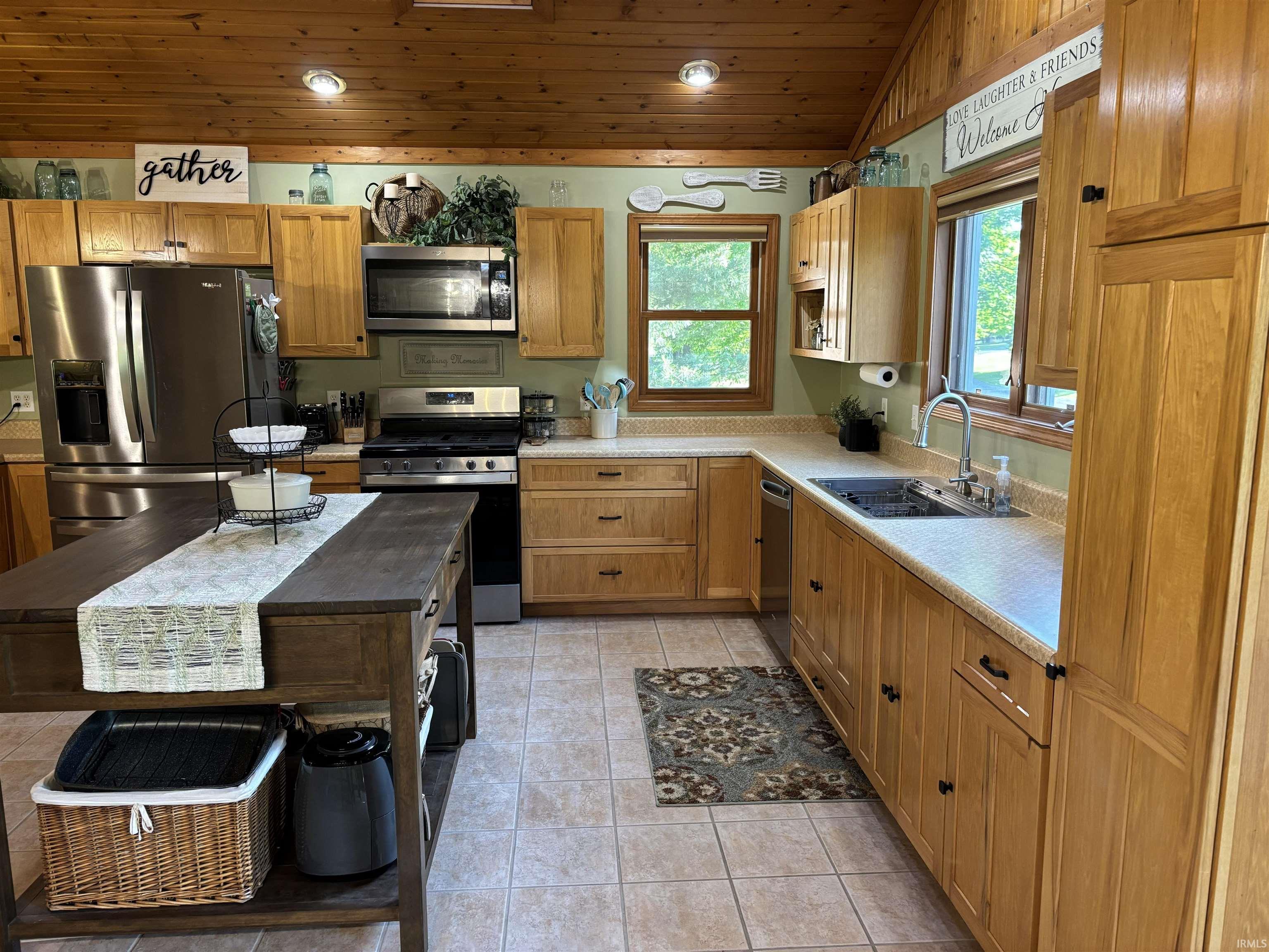 Kitchen featuring wood cabinetry, stainless steel appliances, and a wood-finish ceiling