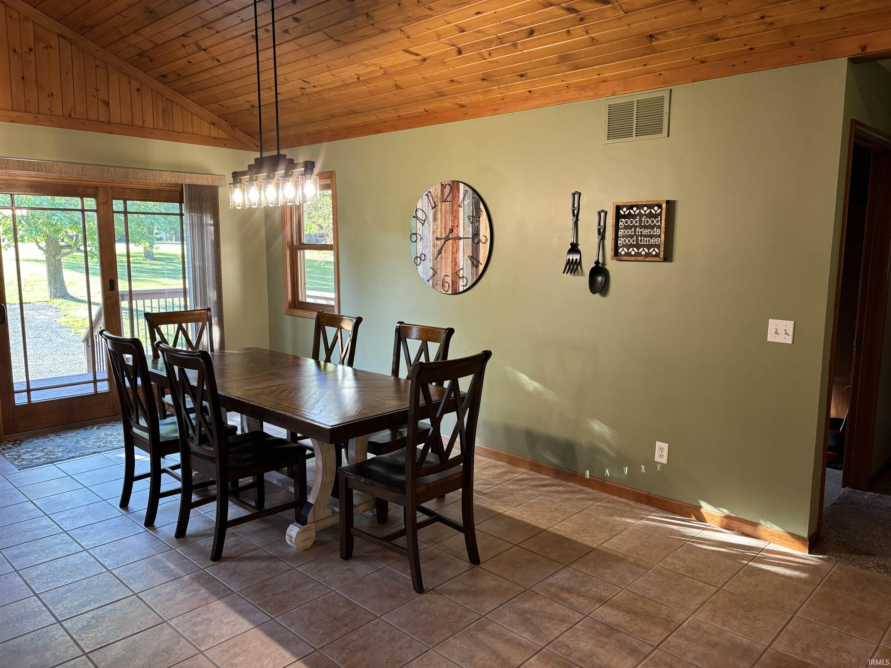 Dining area featuring a vaulted wood-plank ceiling, recessed lighting, and tile flooring