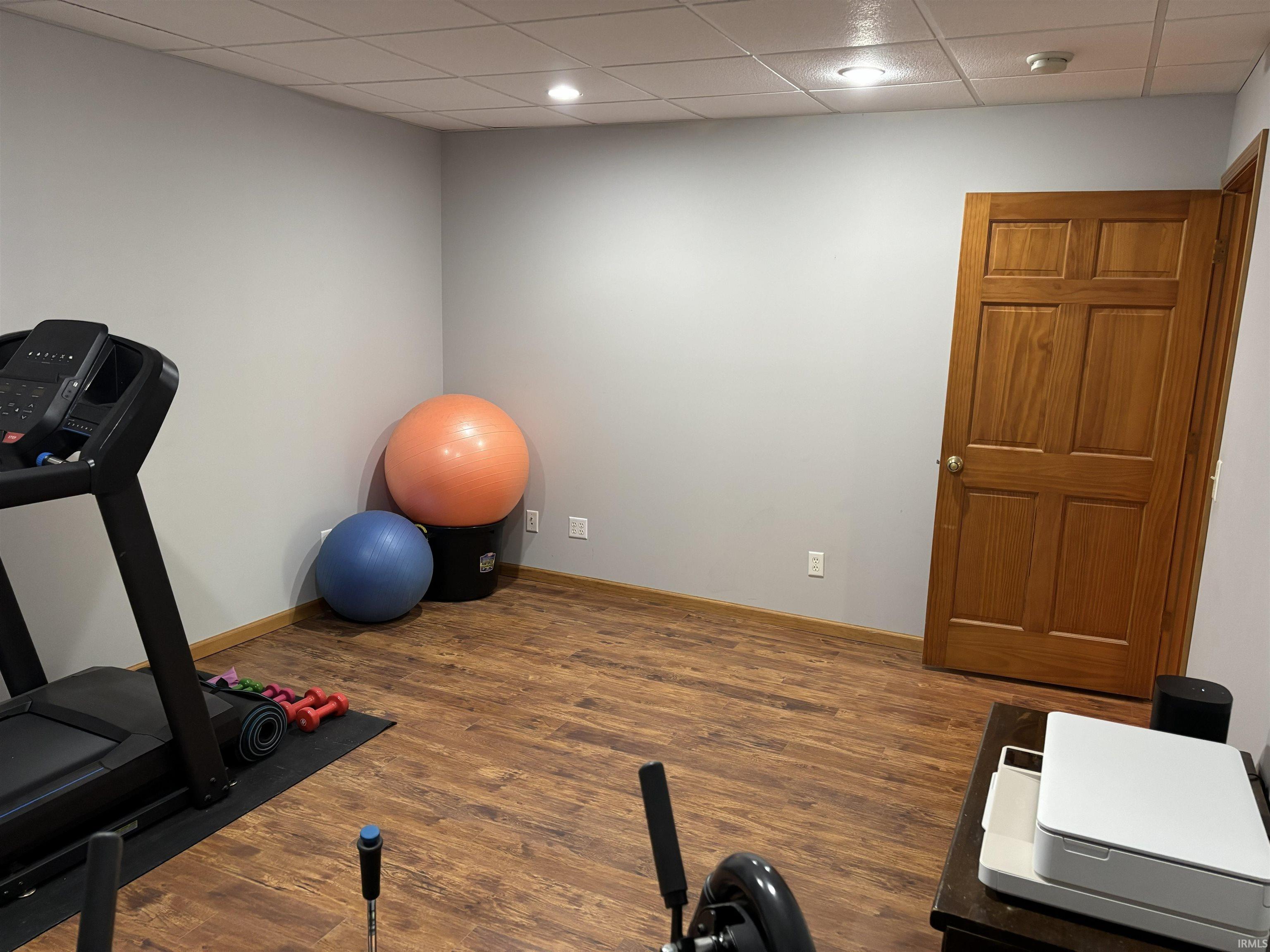 Room featuring wood-finish flooring, recessed lighting, and a neutral wall palette