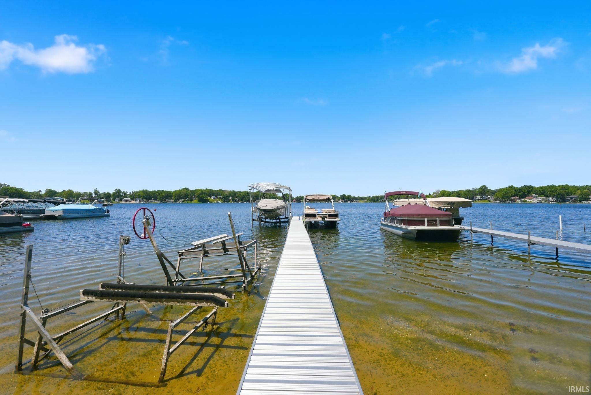 Aluminum dock extending into the lake, featuring multiple boat lifts and docking areas