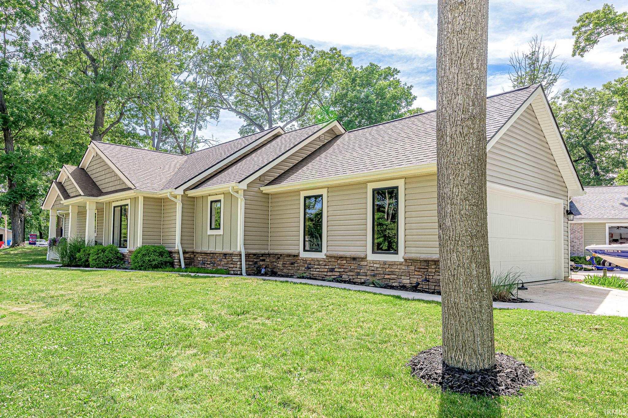 Exterior featuring horizontal siding, vertical accents, and a stone veneer foundation