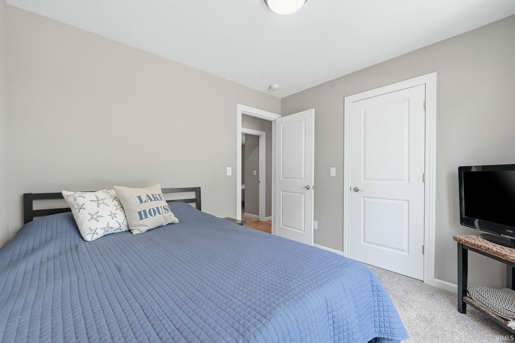 Neutral-toned walls complement the light-colored carpet flooring