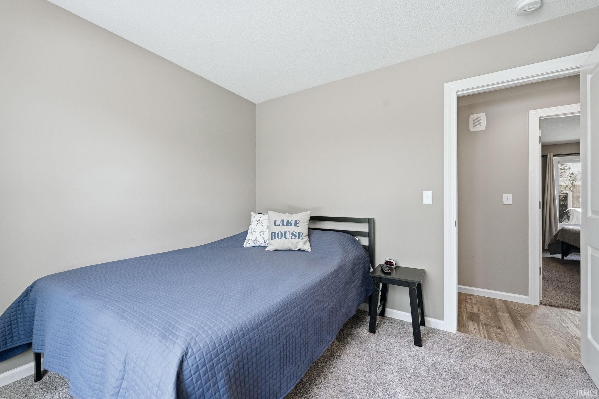 Carpeted room featuring neutral wall tones and white trim