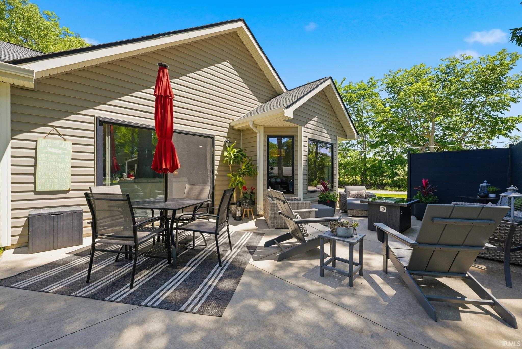 Expansive concrete patio offering multiple defined areas for outdoor living