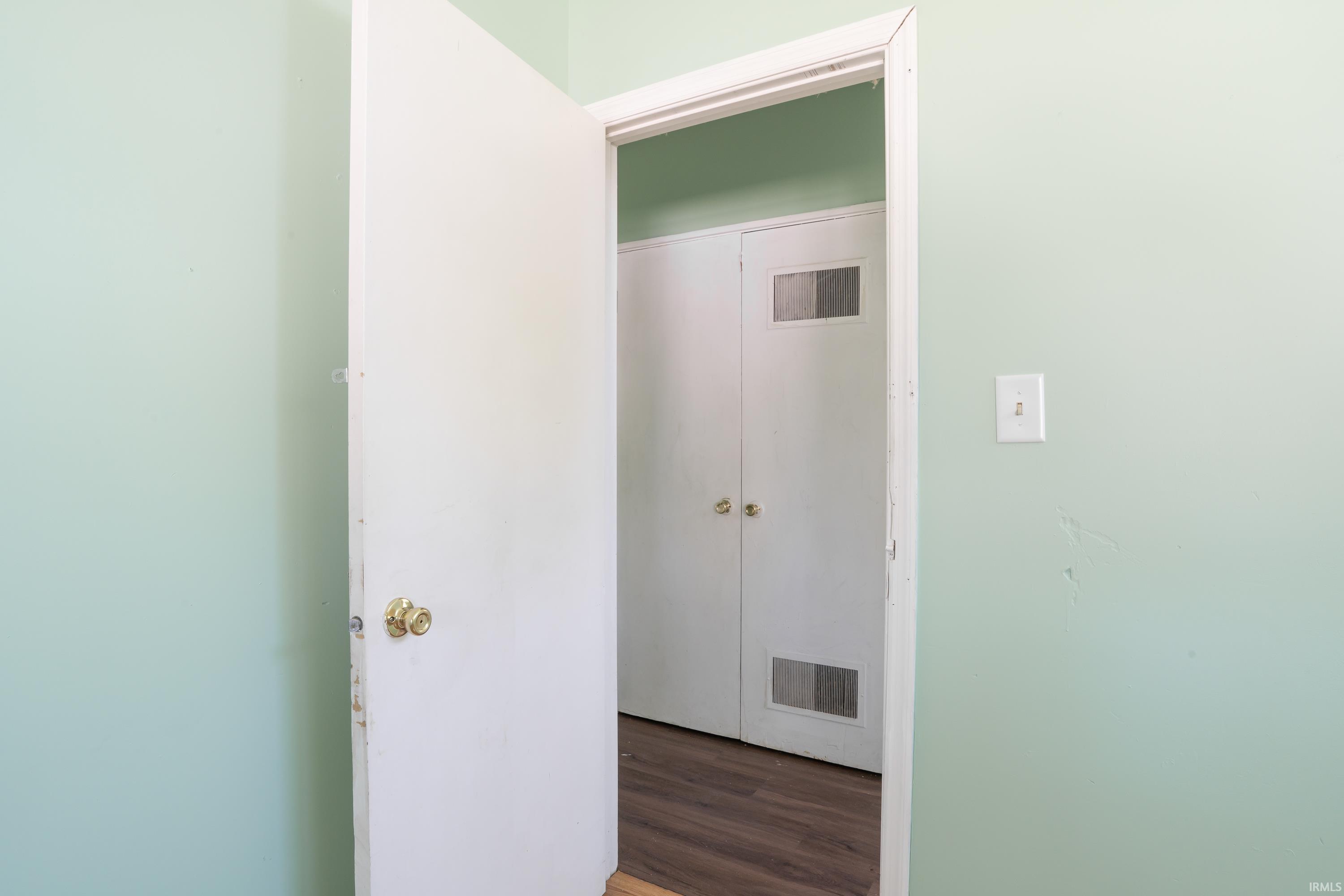 Interior doorway revealing bifold closet doors with louvered panels