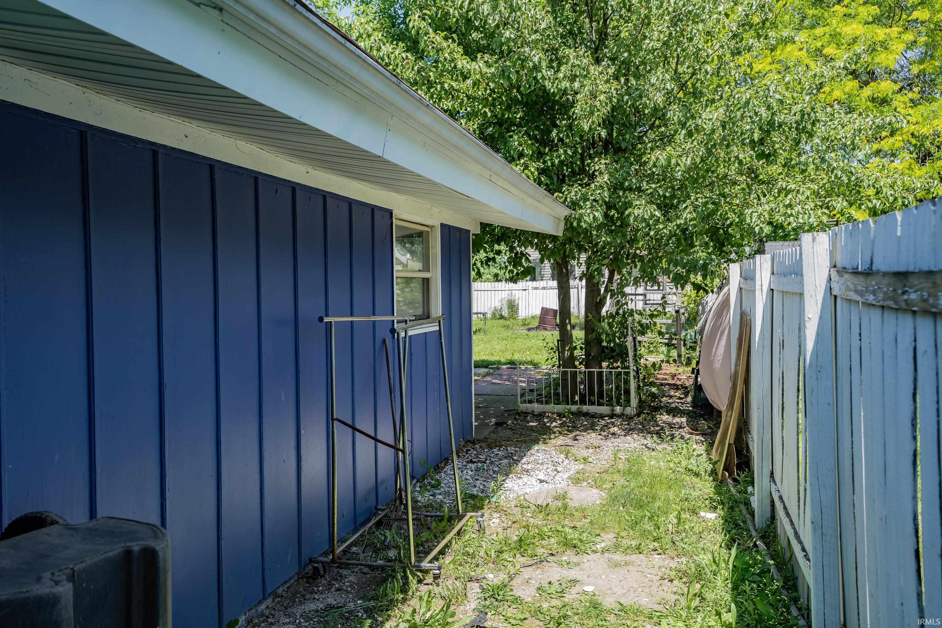 Blue vertical siding exterior featuring a white framed window