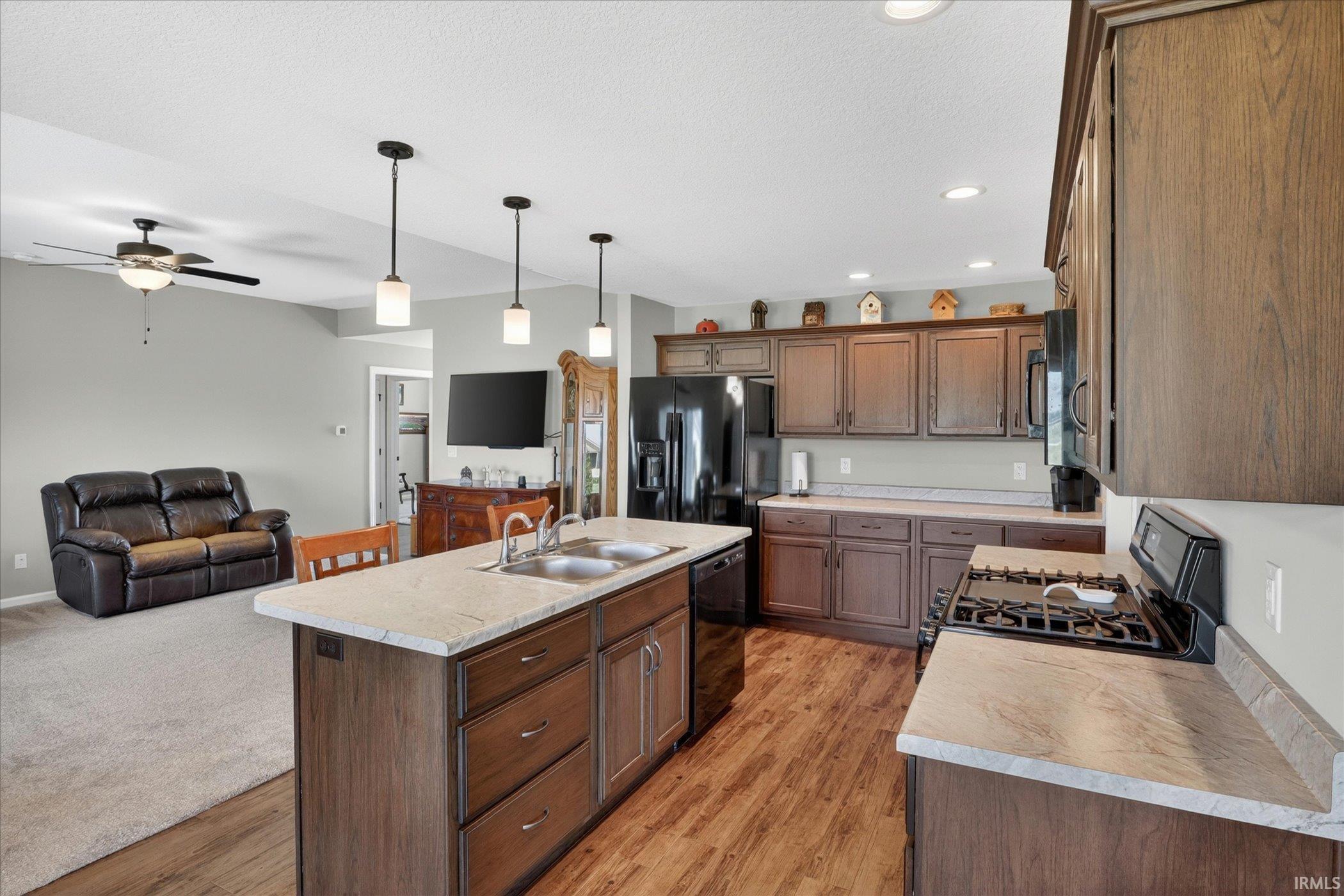 Kitchen island featuring an undermount double sink with a gooseneck faucet