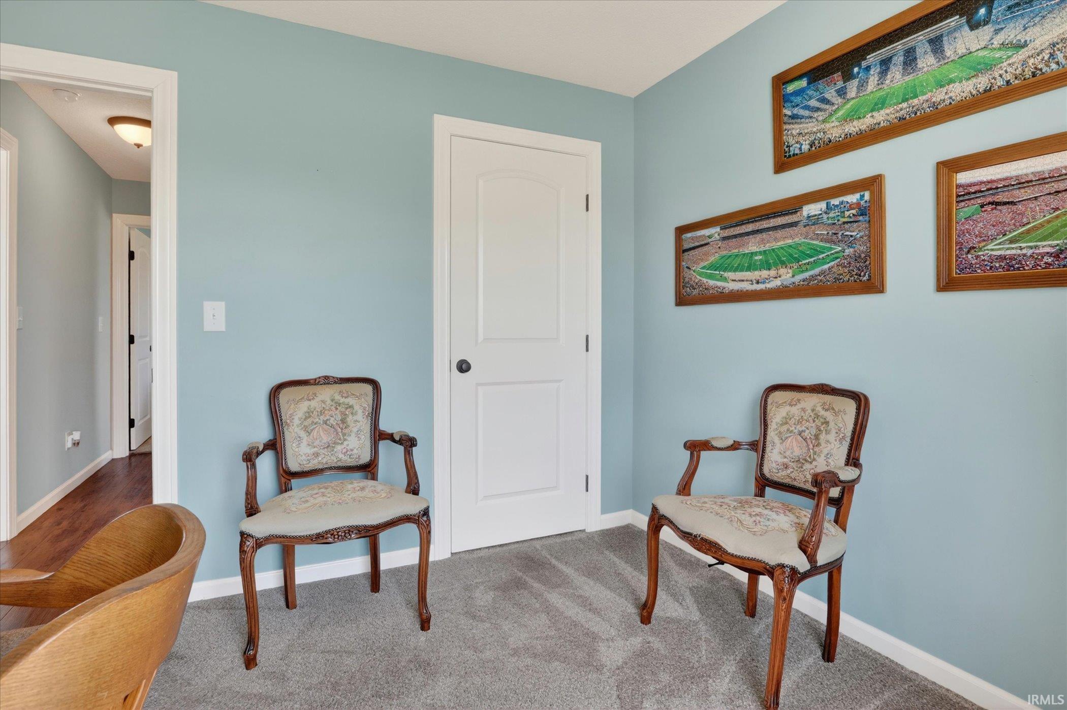 Room featuring light blue wall paint and gray carpet flooring