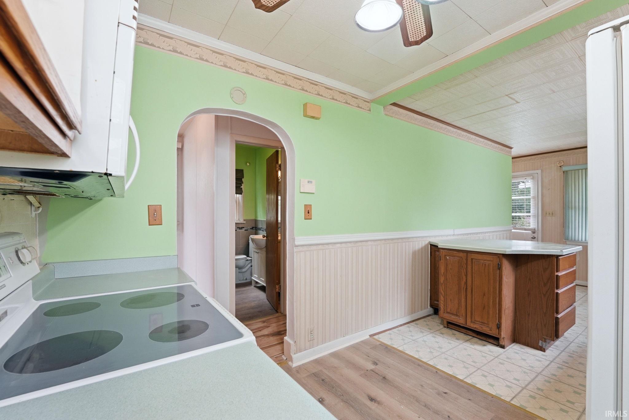 Kitchen featuring a built-in range, overhead microwave, and wood cabinetry