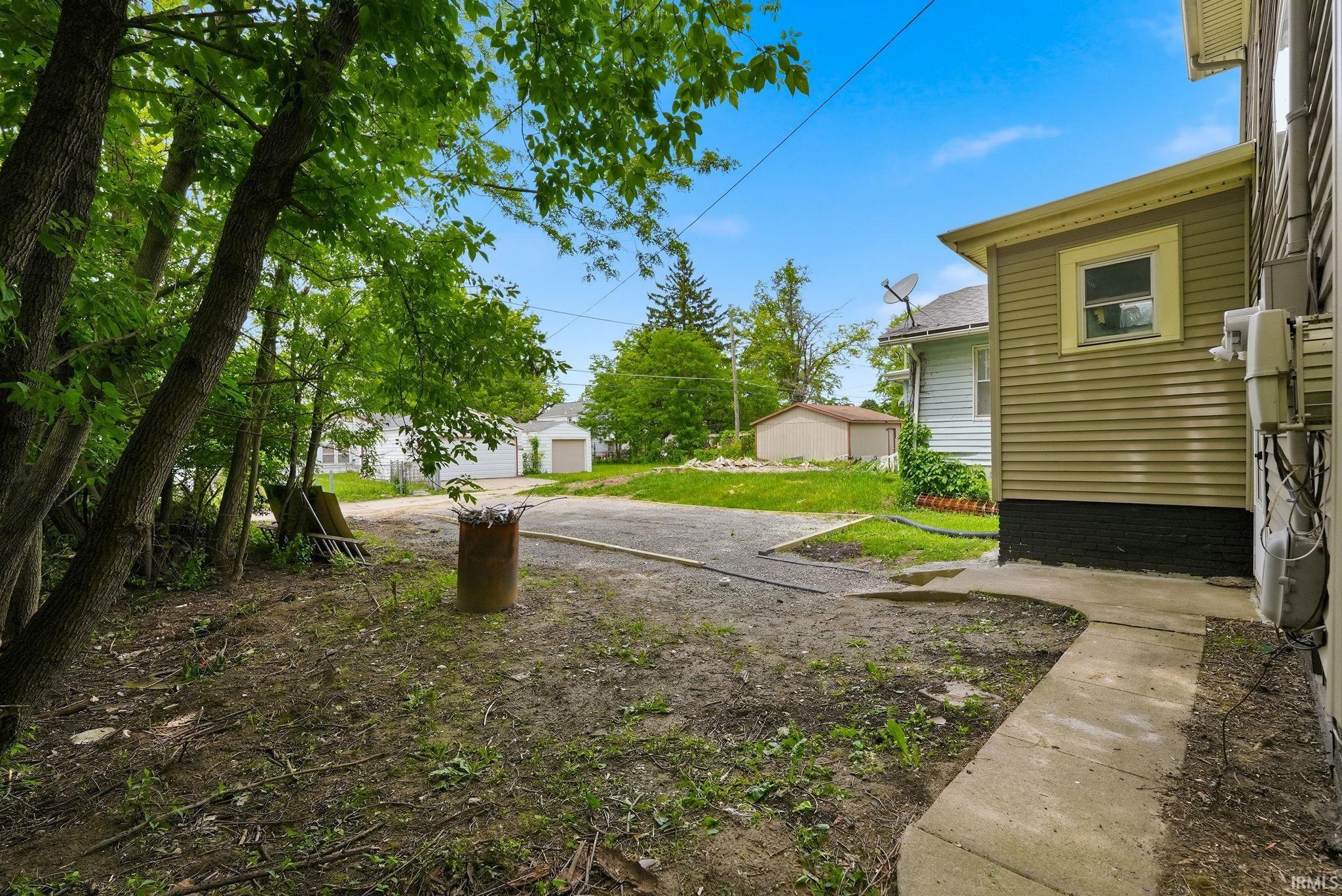 Exterior siding in a neutral tone with a contrasting dark foundation