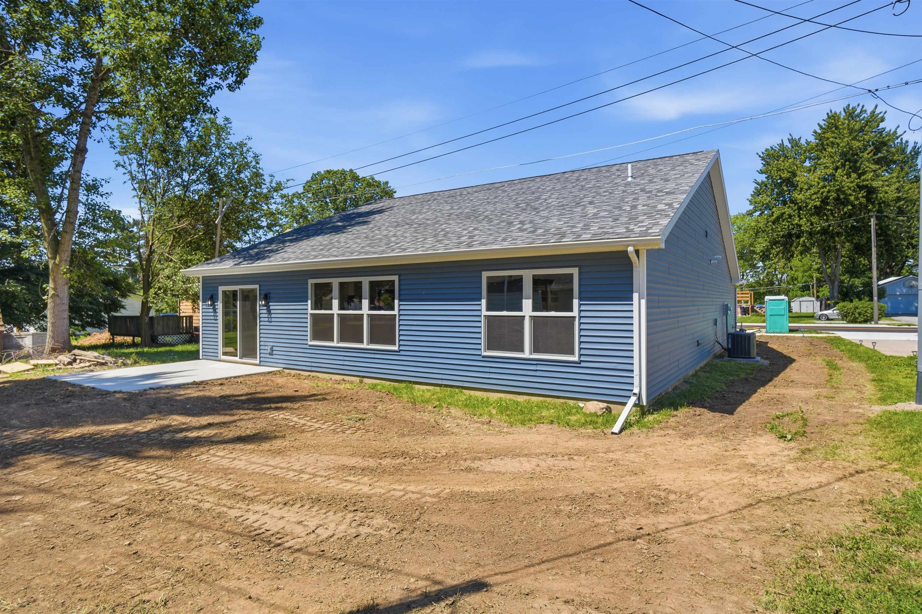Blue horizontal siding with a shingled roof