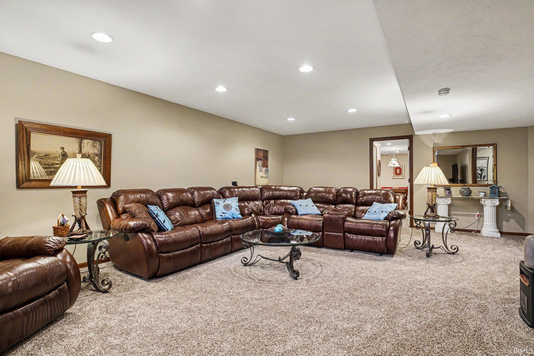 Spacious room featuring neutral carpeting and recessed lighting