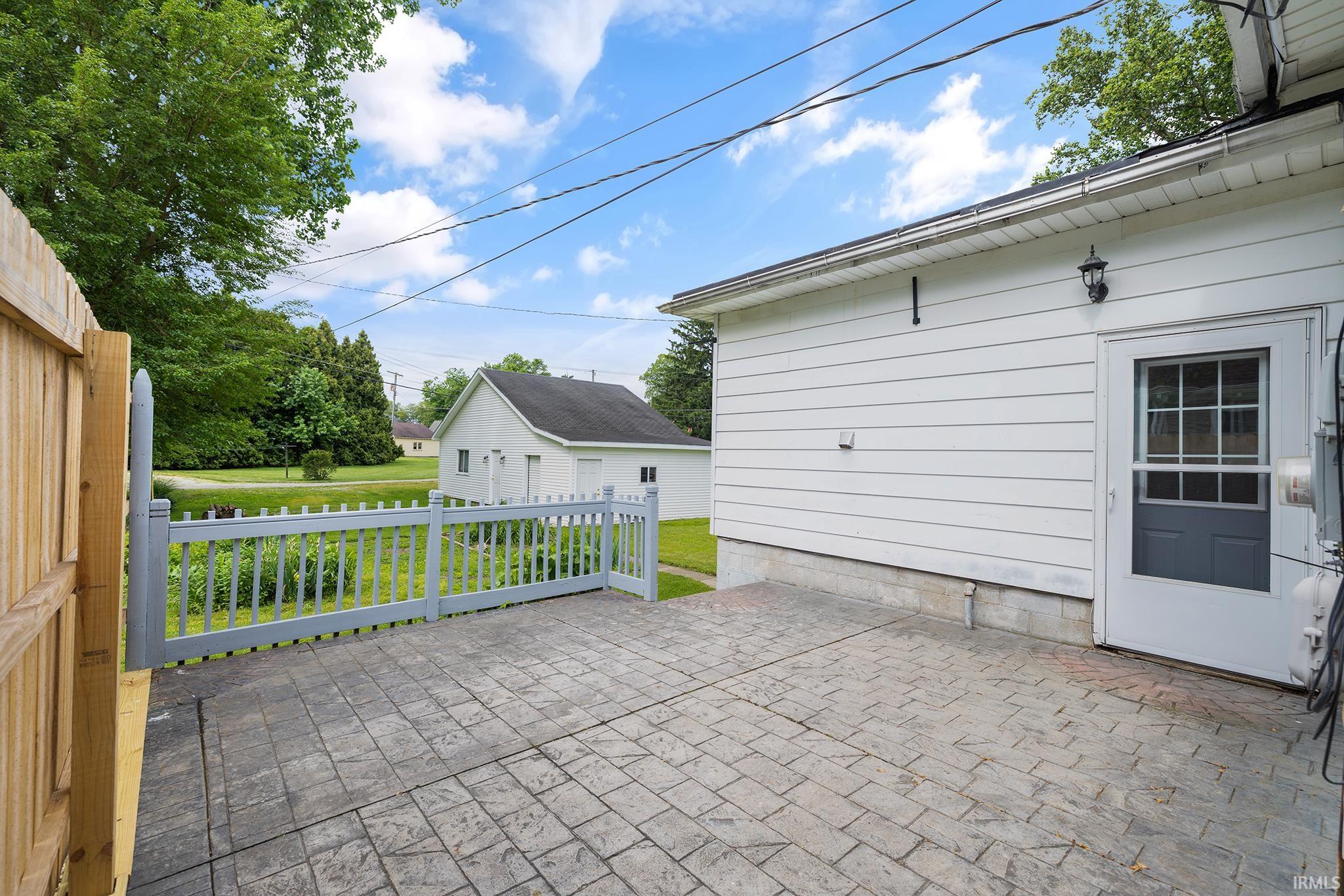 Stamped concrete patio with a decorative picket fence
