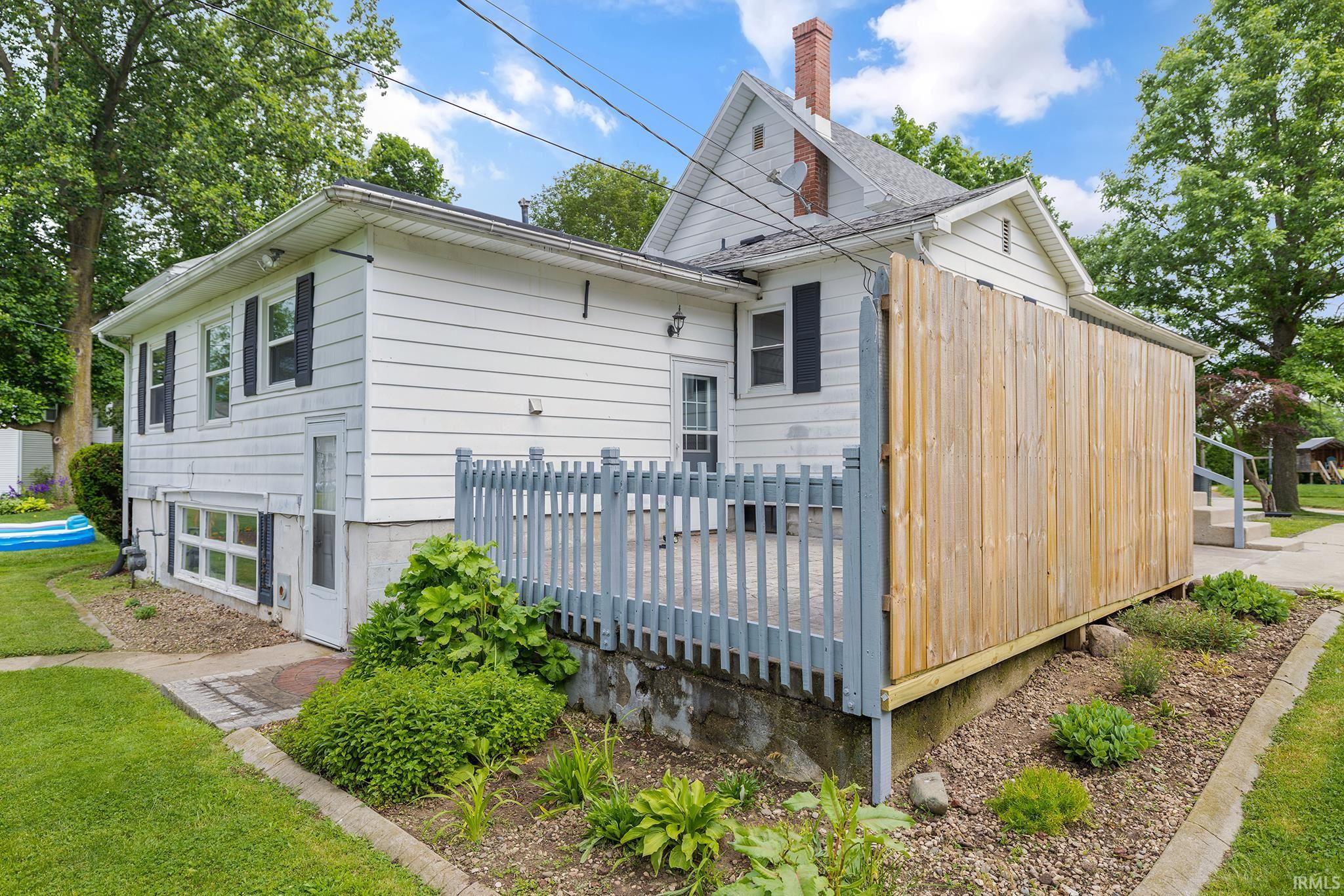 Exterior deck with a privacy fence, complemented by a landscaped garden bed