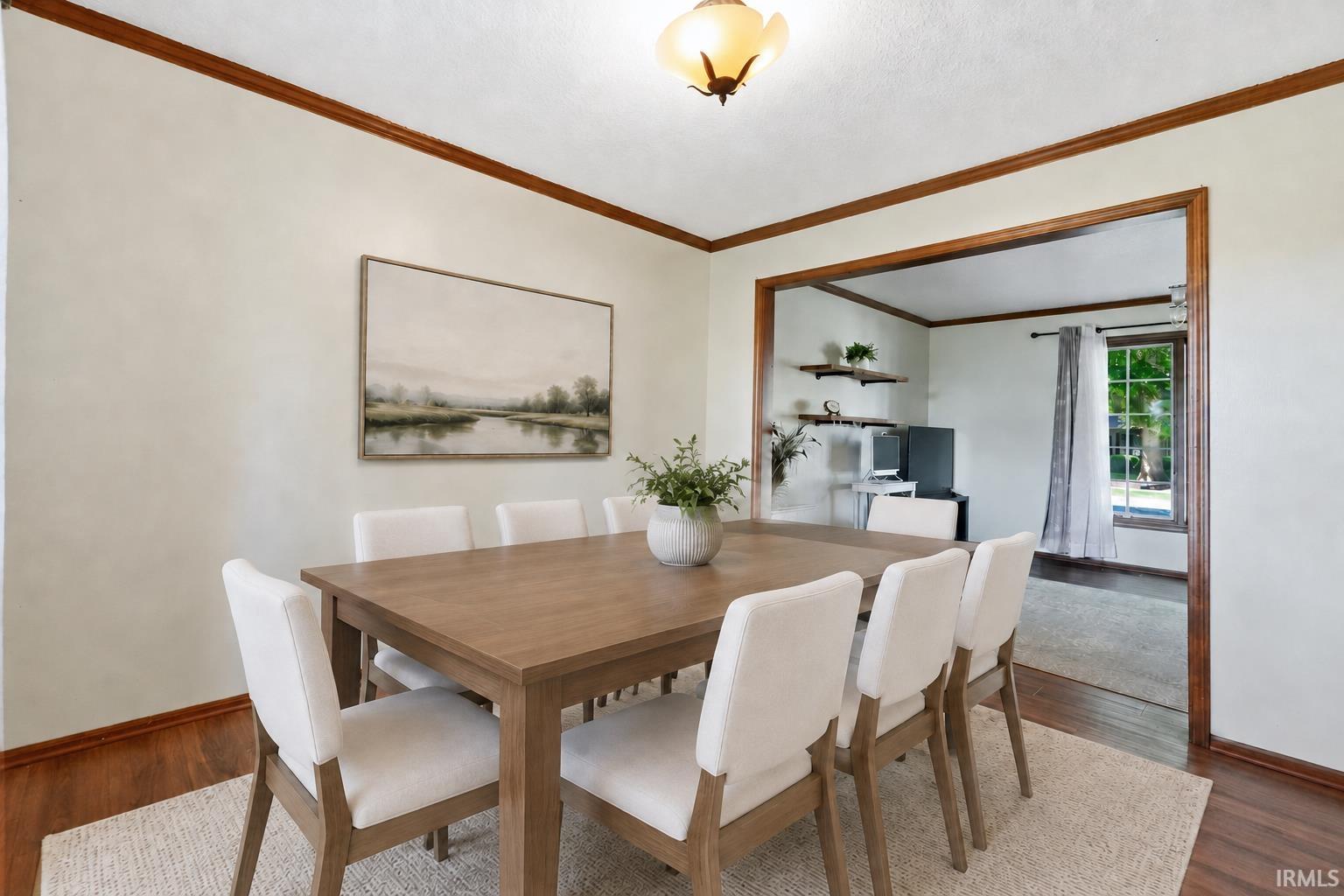 Recessed ceiling light fixture, wood-finish flooring, wood-framed doorway, wood trim, and light-toned wall finish