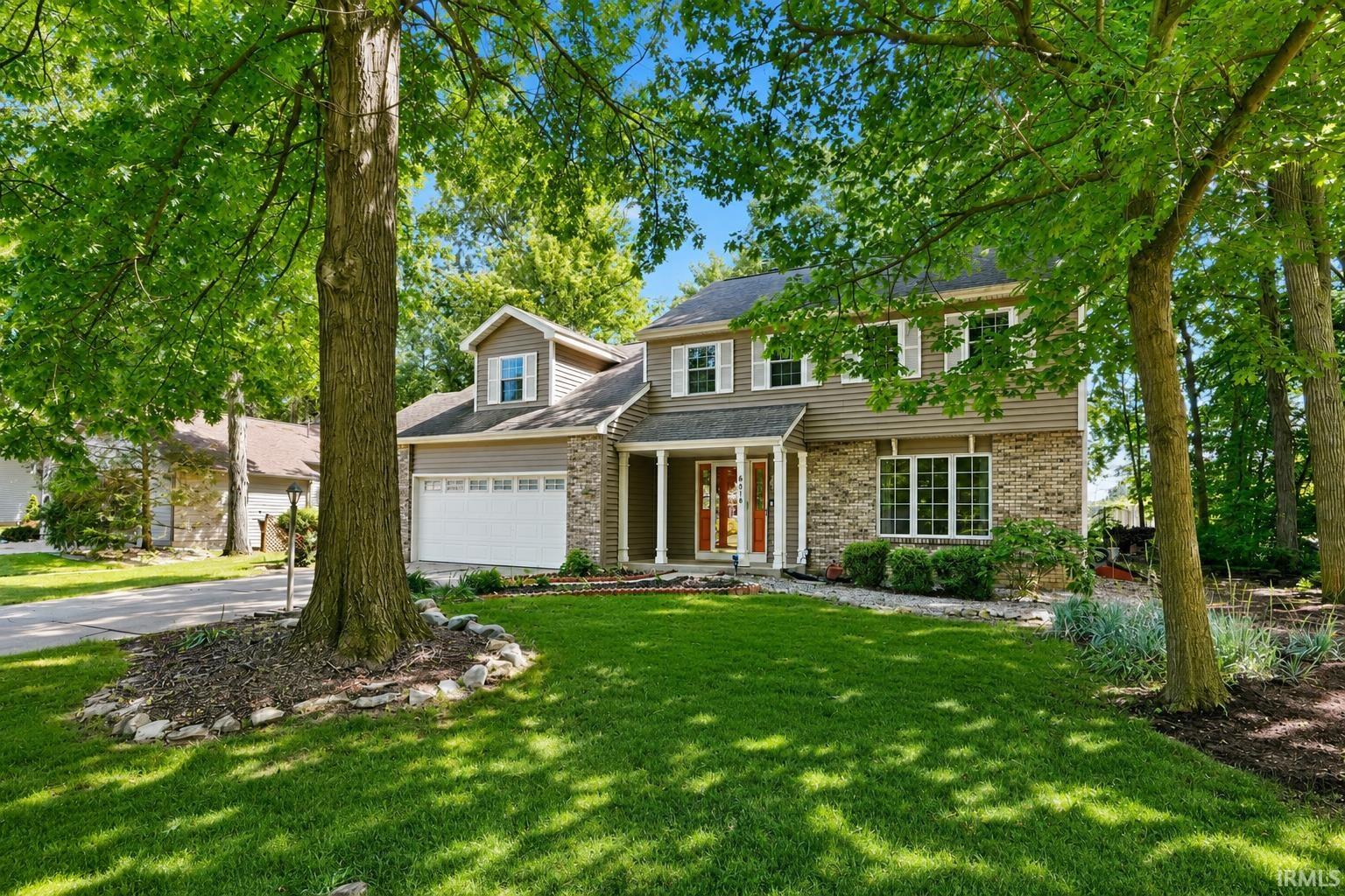 Two-story exterior with horizontal siding and brick accents