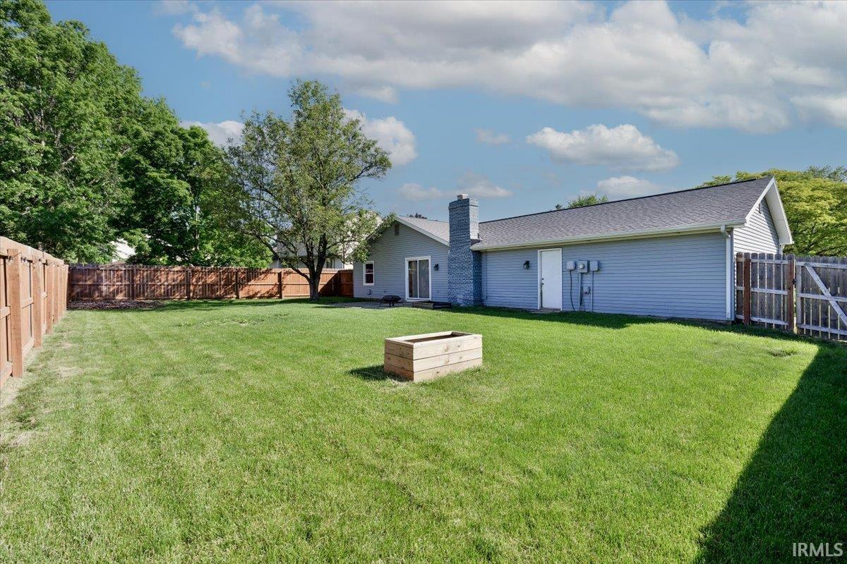 Expansive green lawn with complete wood fencing