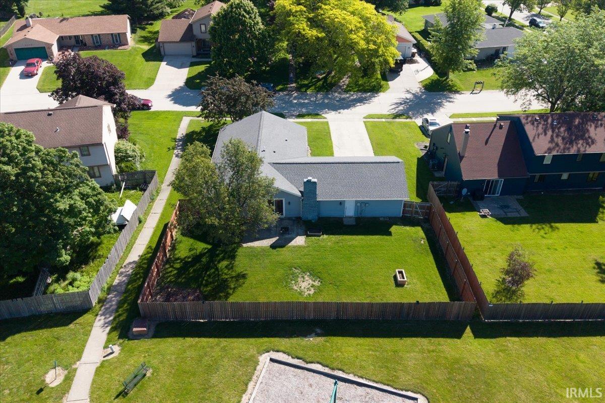 Single-story residence featuring a gray shingle roof and light blue siding