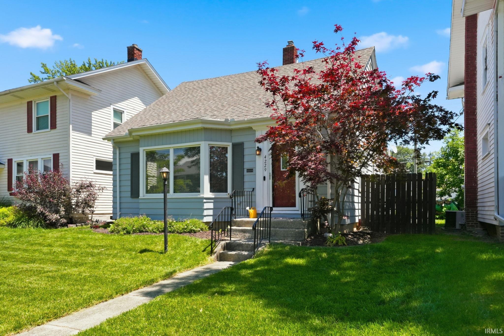 Light blue exterior with bay window and dark shutters