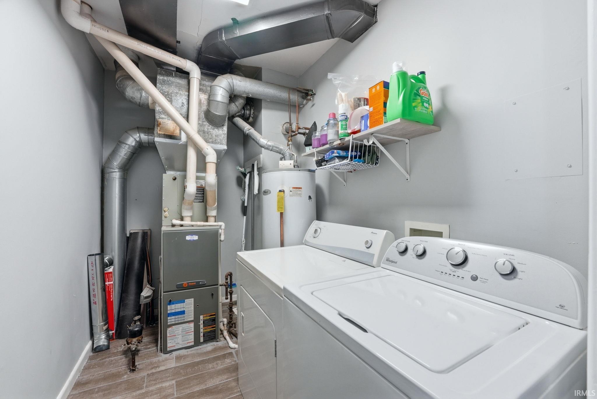 Dedicated utility area featuring a washer and dryer, water heater, and furnace