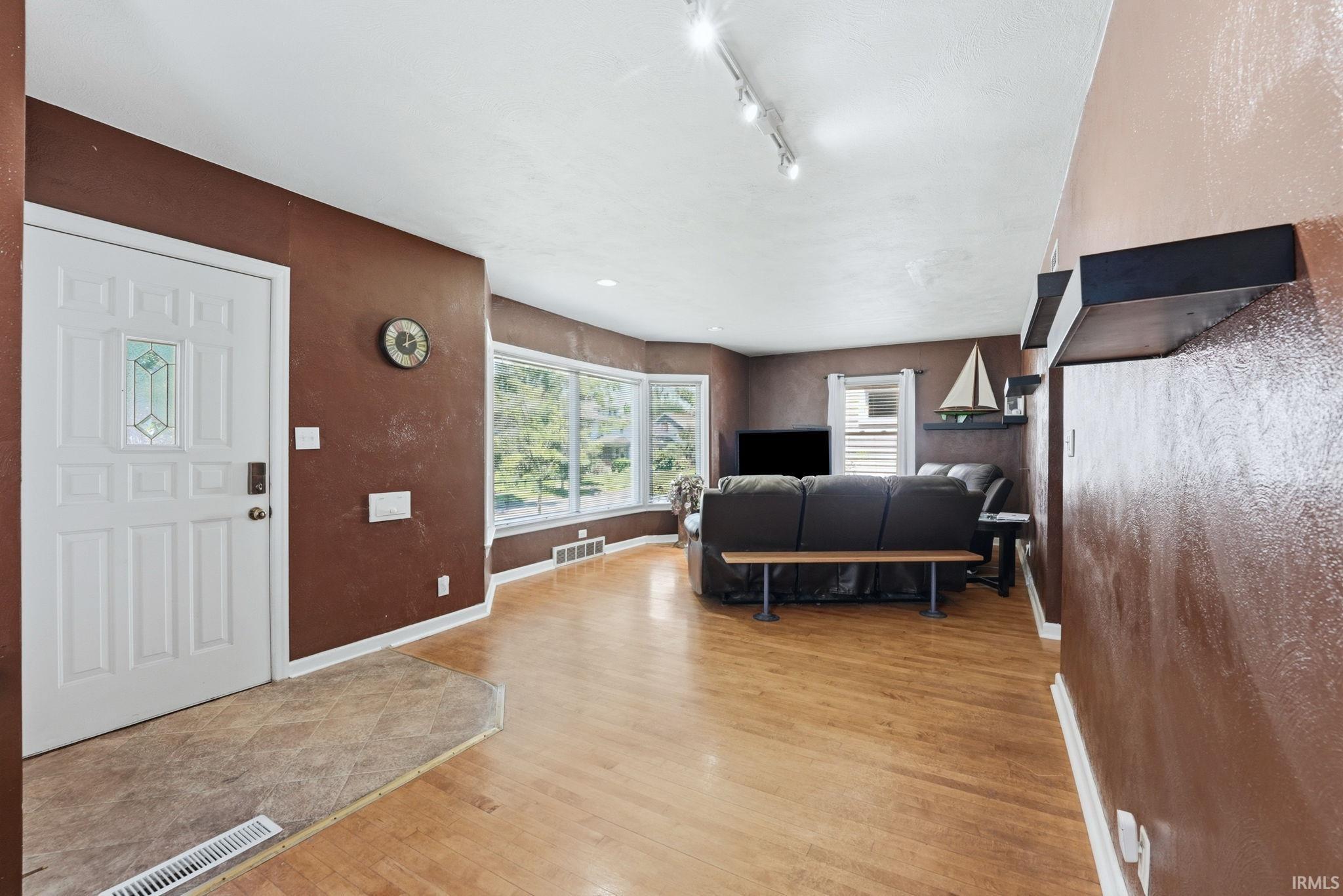 Bright living area featuring wood-finish flooring and a white ceiling