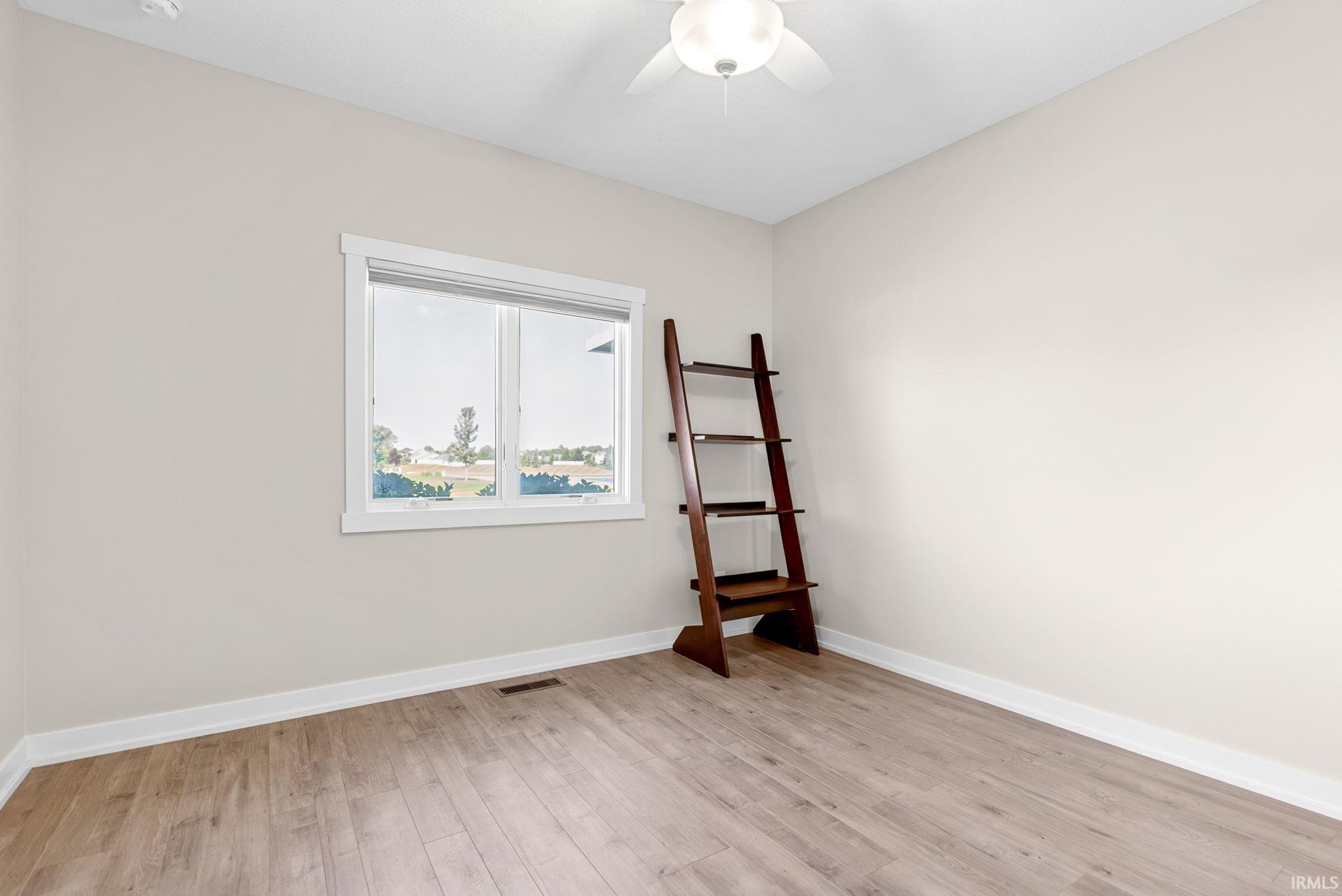 Room featuring light wood-finish flooring and a ceiling fan