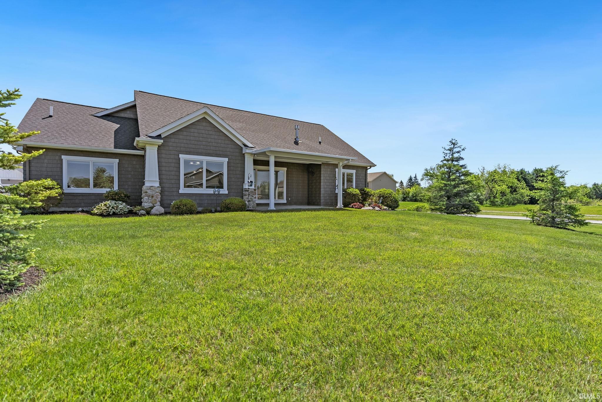 Spacious single-story residence with gray shingle siding