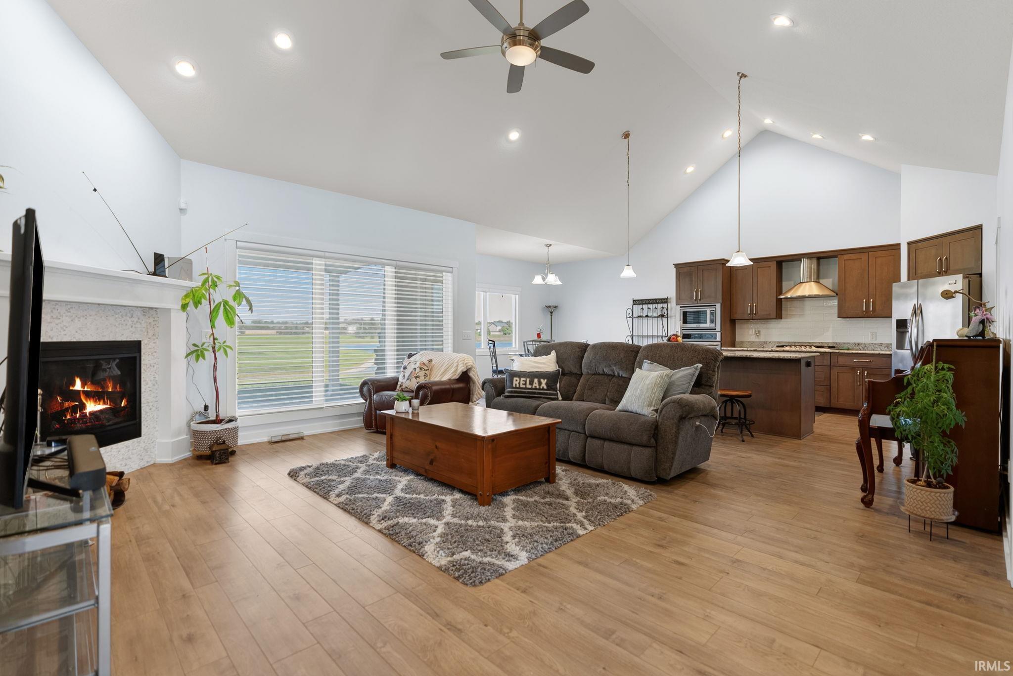 Vaulted ceilings complement the open-concept living space with wood-finish flooring