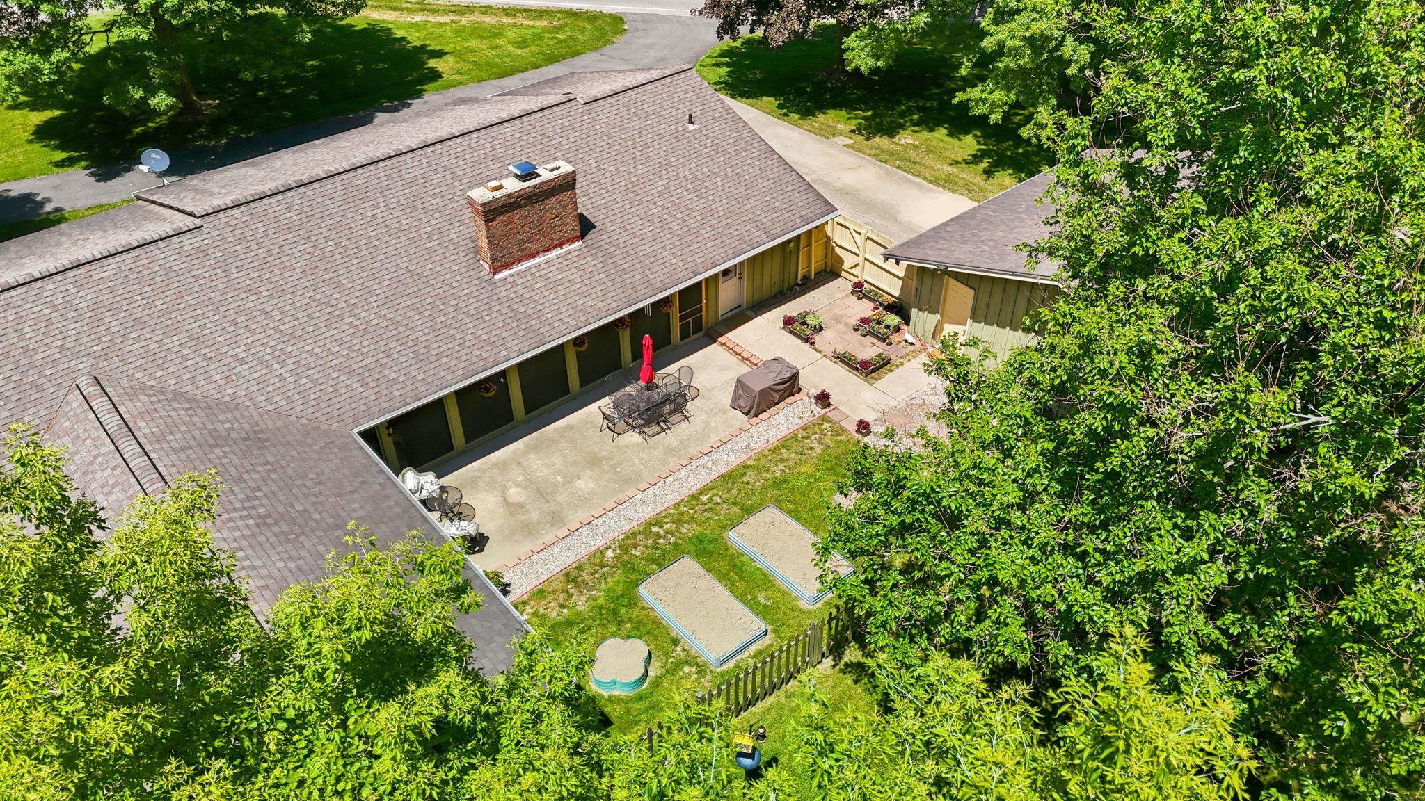 Expansive outdoor patio with concrete pavers and brick edging