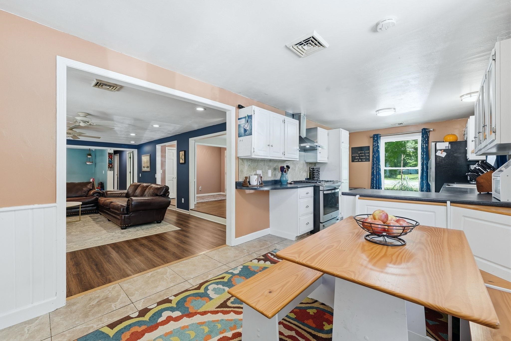 Spacious kitchen featuring white cabinetry, dark countertops, and tile flooring