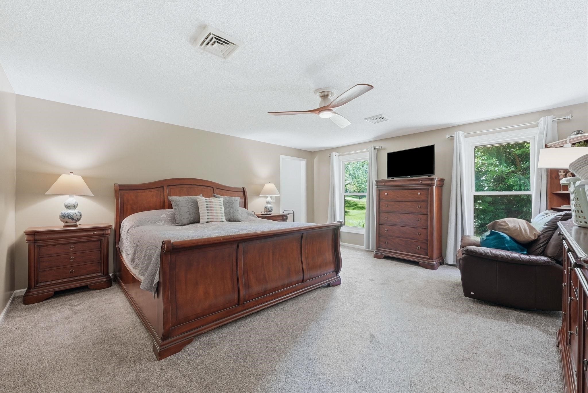 Spacious room featuring neutral carpeting and light-colored walls